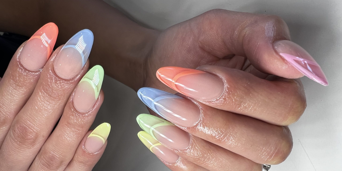 Long almond-shaped nails featuring colorful pastel French tips in pink, blue, green, yellow, and orange with glossy nude bases.