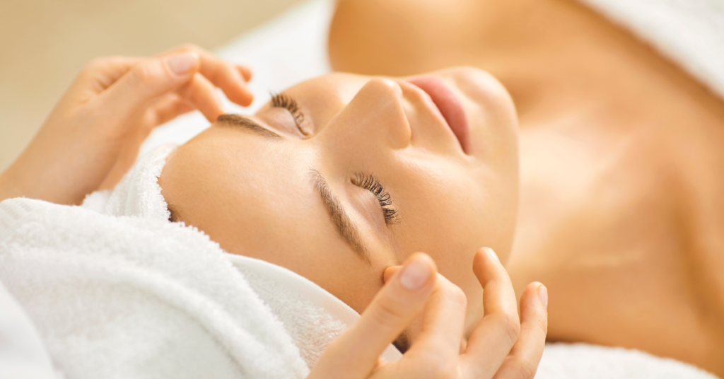 Relaxing spa facial treatment with a woman lying comfortably on a treatment bed with her eyes closed