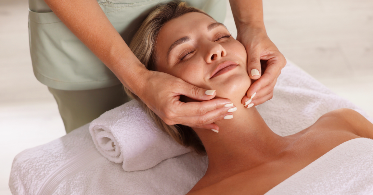 Relaxing facial massage treatment at a spa with a client lying comfortably on a treatment bed.