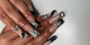Luxury black-and-white nail art with rhinestones.